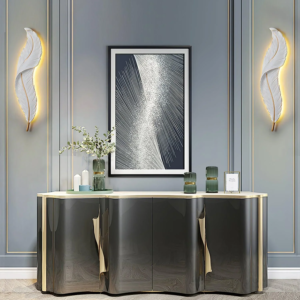 Modern white and gold feather LED wall lamp with sculpted resin design.