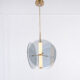 Gold LED pendant light with glass and acrylic construction for modern interiors.