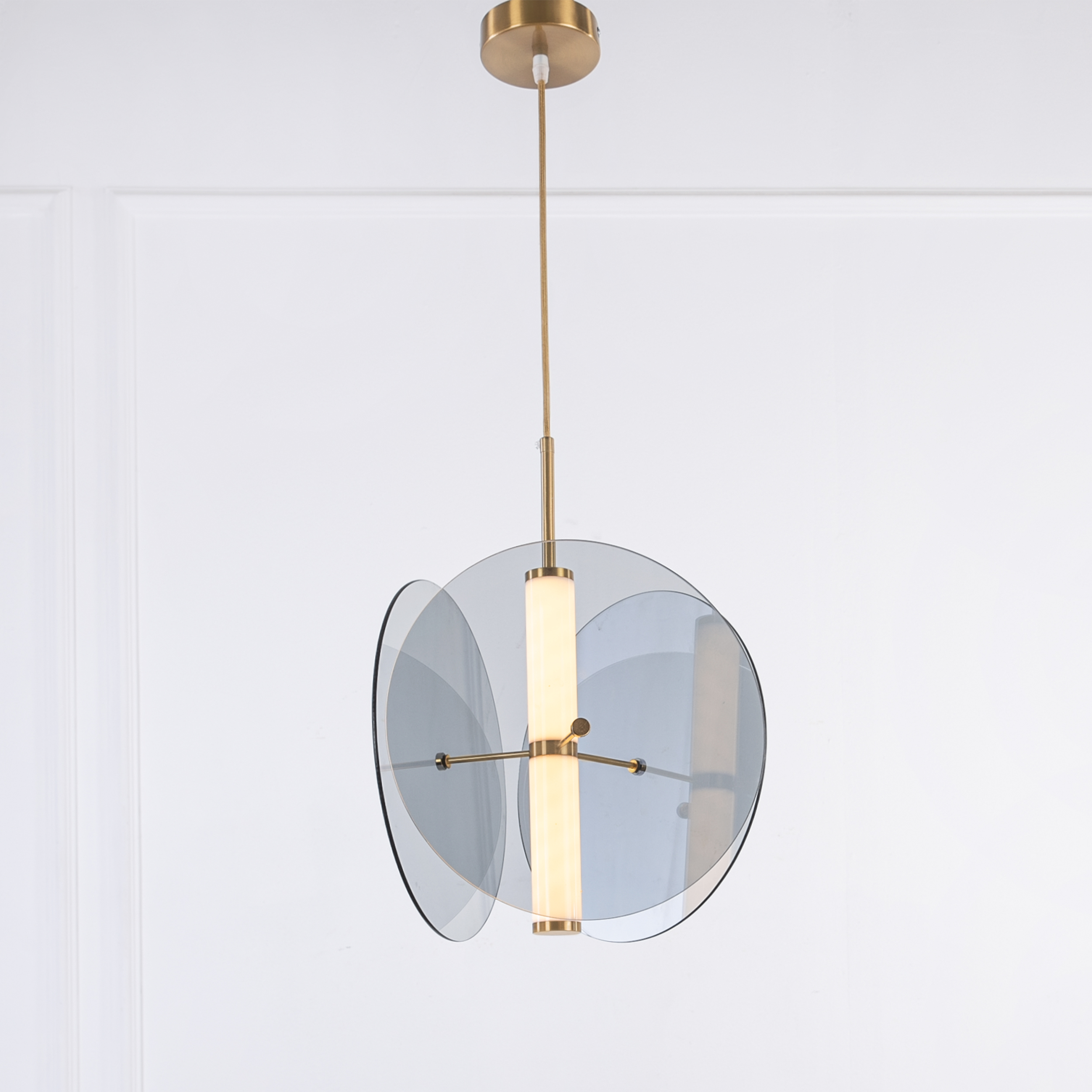 Gold LED pendant light with glass and acrylic construction for modern interiors.