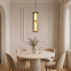 Modern cylindrical glass LED pendant ceiling light with warm ambient illumination for contemporary interiors.