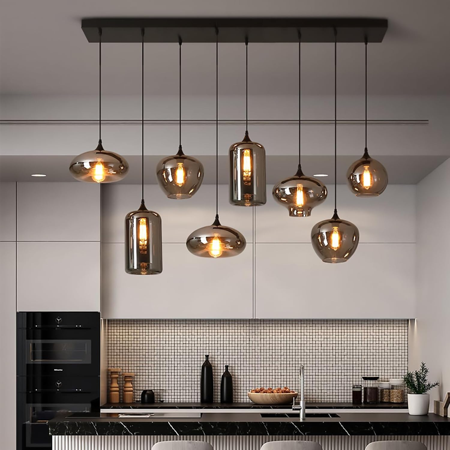 Modern linear pendant chandelier with amber glass shades suspended from a black ceiling canopy for dining room and kitchen island lighting