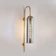 Modern metal wall light with hand-blown glass shade available in Champagne Smoke Glass and Amber Glass finishes.